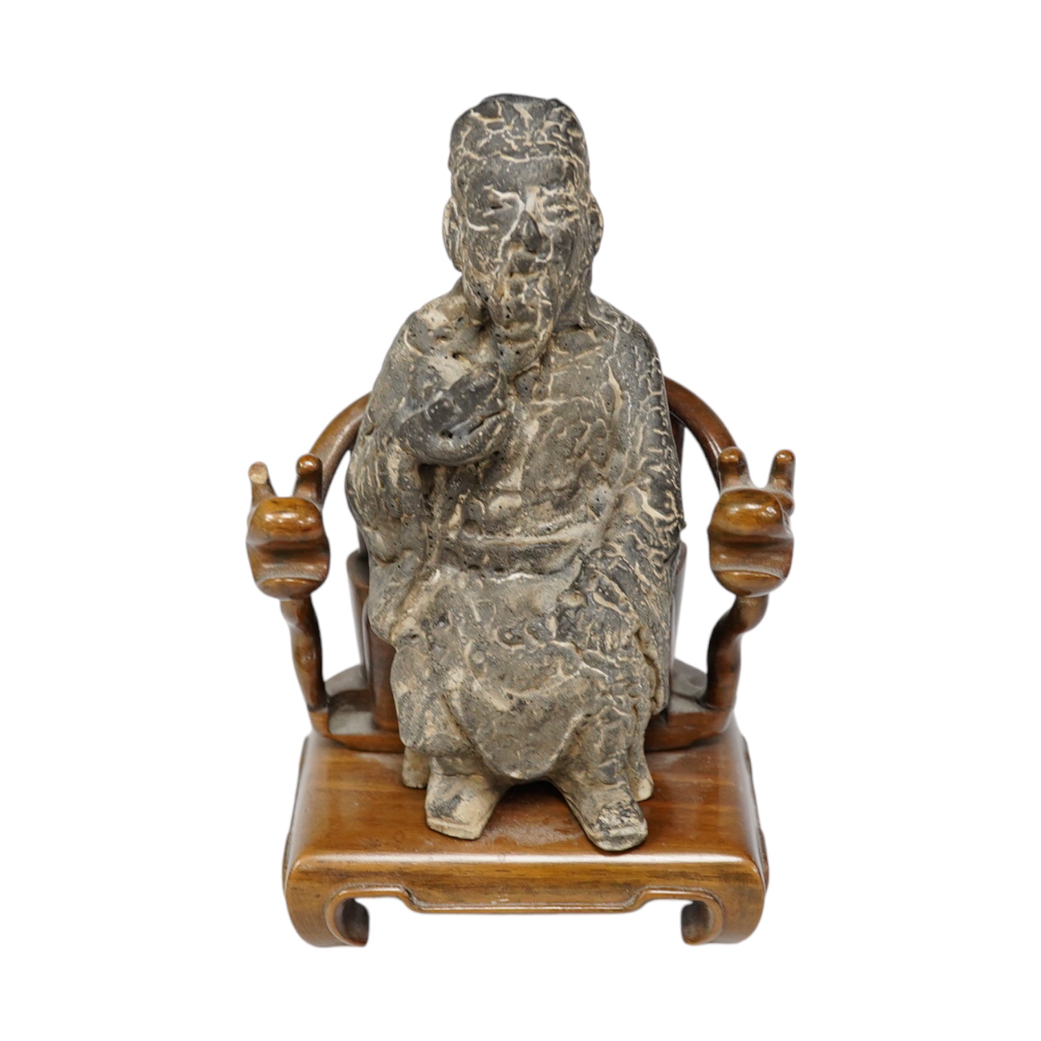 A Chinese grey pottery seated figure of a God, possibly Ming dynasty, seated on a later wood throne (with receipt of purchase from C C Tih Gallery, Hong Kong, 1968), 15cm high. Condition - fair